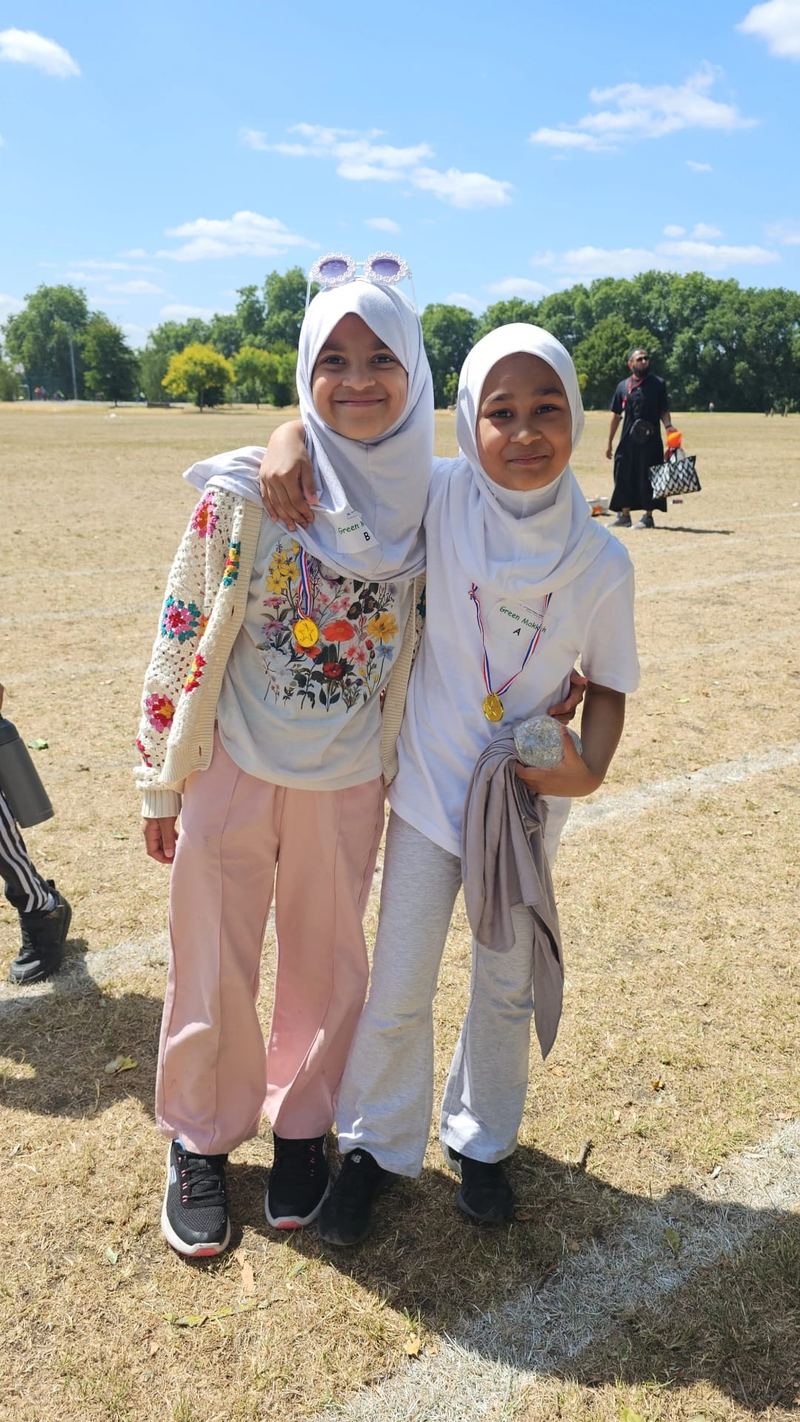 Two pupils smiling together at Sports Day