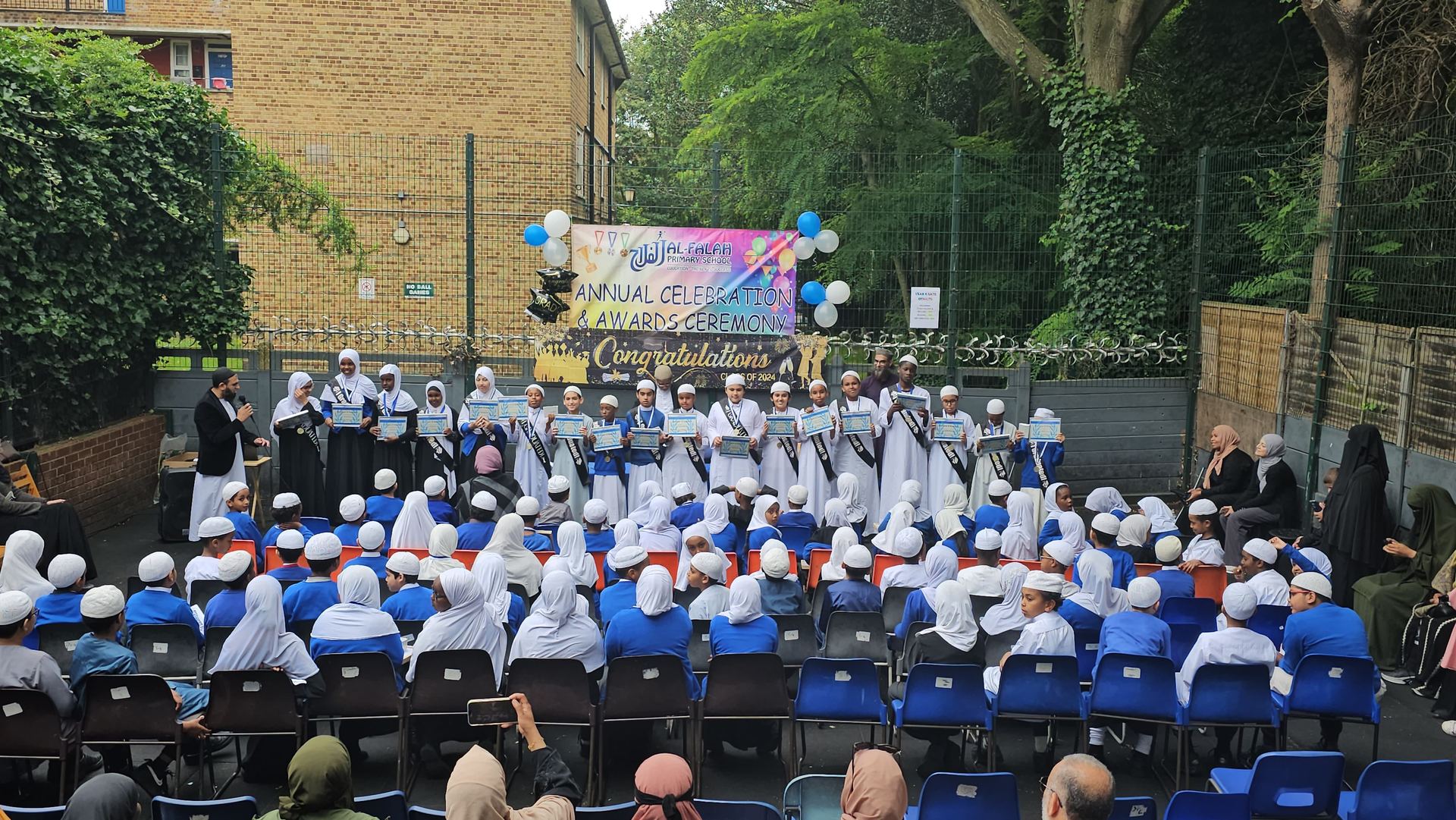 Pupils receiving certificates at the Al-Falah Annual Celebration and Awards Ceremony
