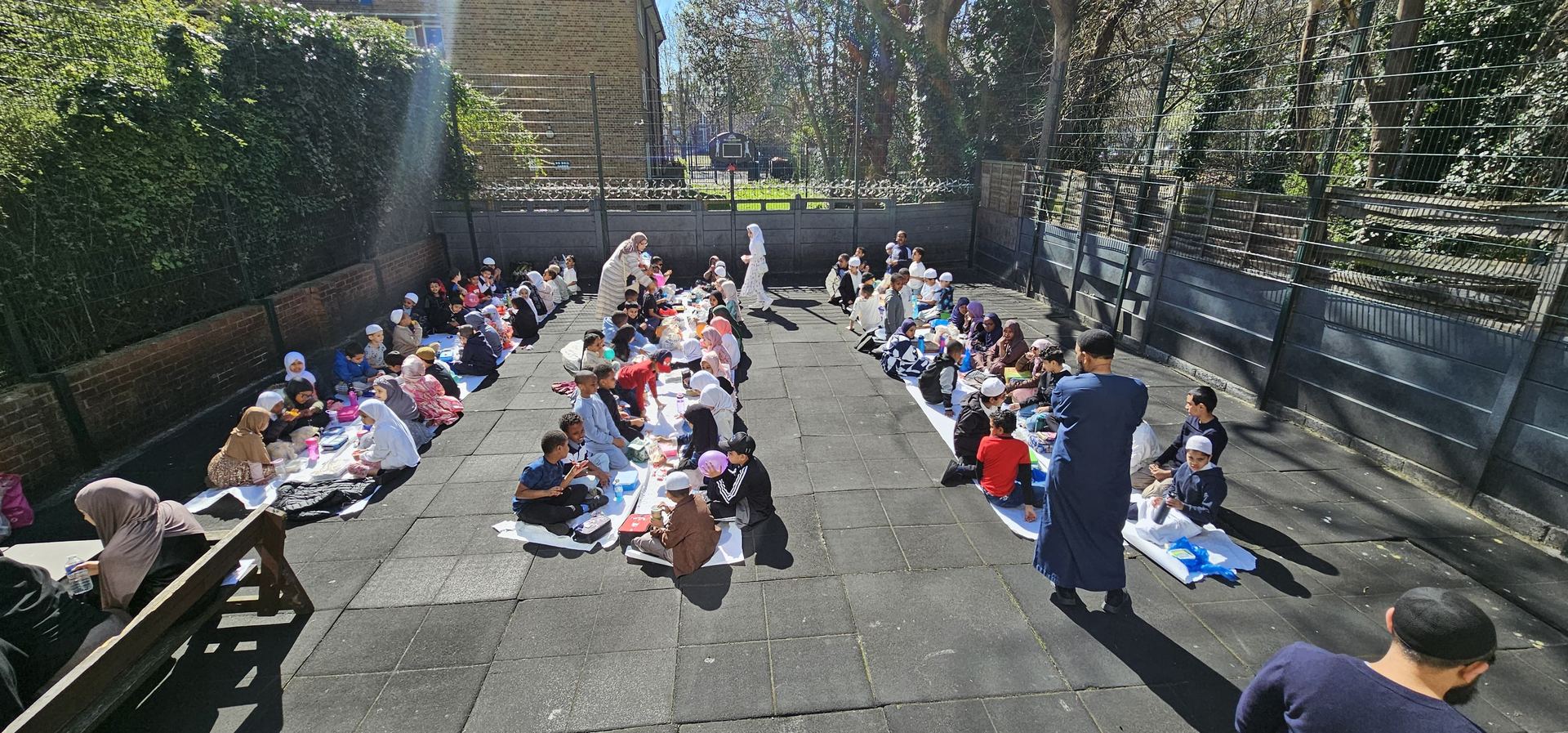 Pupils sharing a community meal outdoors
