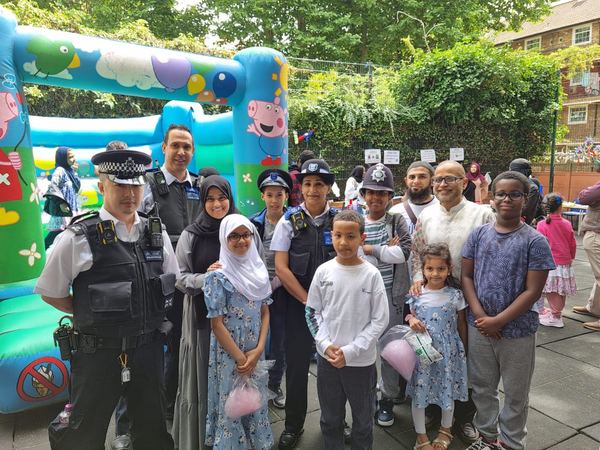 Pupils, families and local police officers at a school community fun day