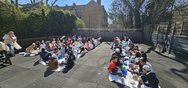 Pupils and families sharing a community meal together