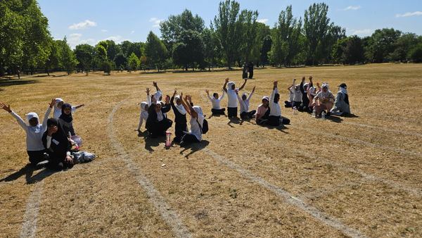 Pupils cheering on the field at Sports Day
