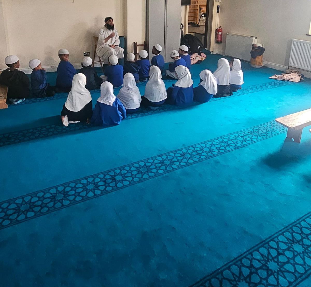 Pupils sitting together in the prayer hall