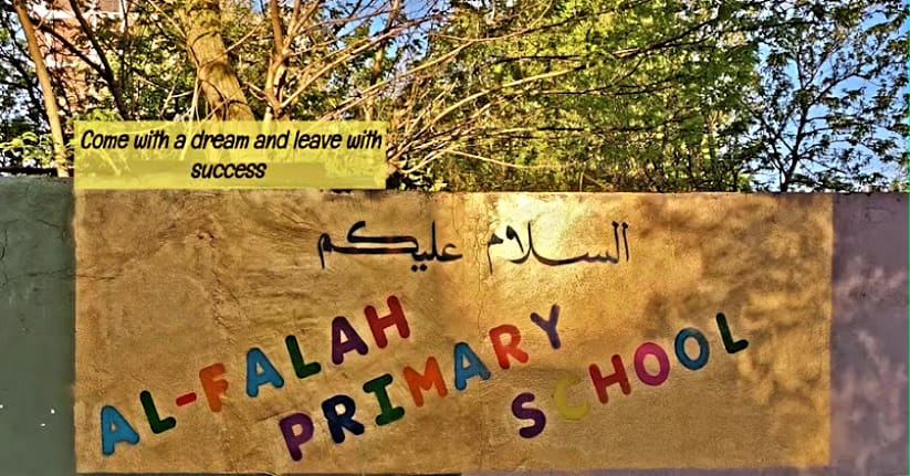 Al-Falah Primary School sign: Come with a dream and leave with success
